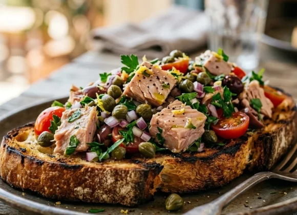 The Best Mediterranean Tuna Salad Recipe (No Mayo) A scoop of vibrant Mediterranean tuna salad on grilled sourdough bread
